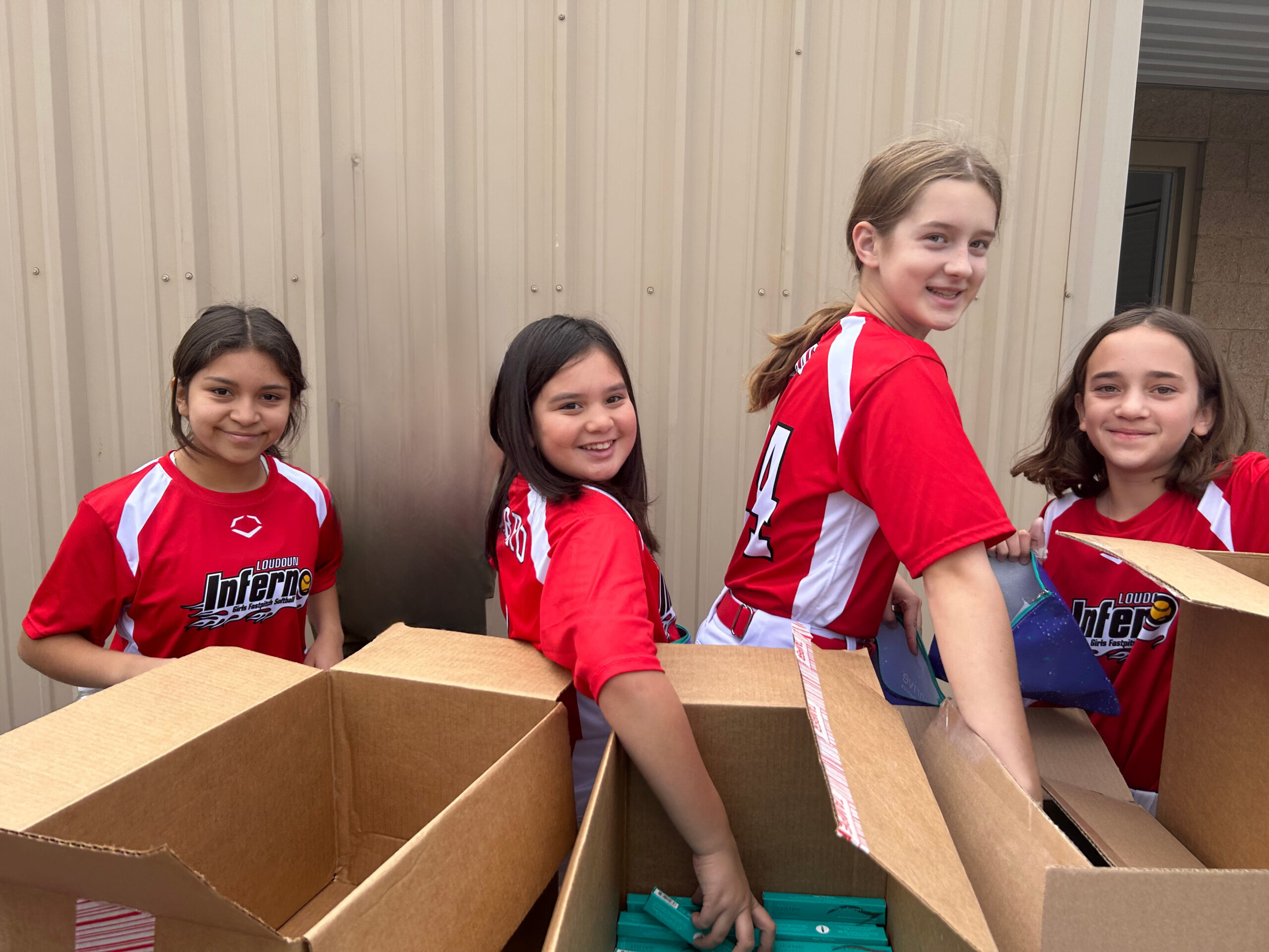 Inferno players assembling chemo care kits with Step Sisters